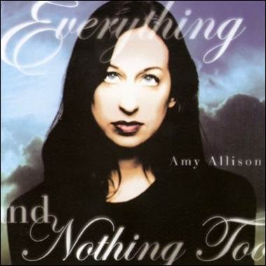 A person with long hair and a black shirt
Description automatically generated