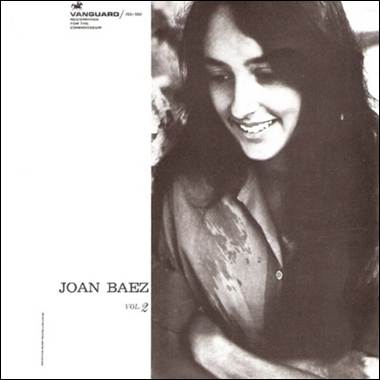 A person smiling with her arms crossed
Description automatically generated