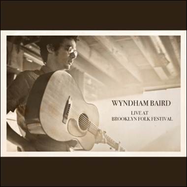 A person holding a guitar
Description automatically generated