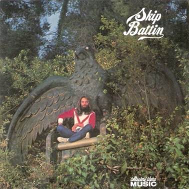 A person sitting in a chair in the woods
Description automatically generated