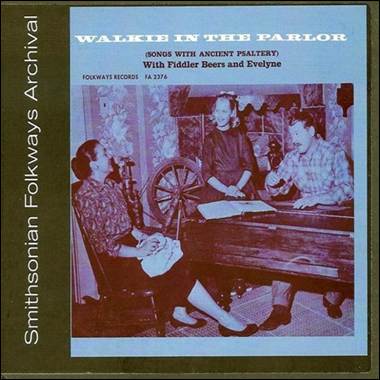 A cd cover of a group of people sitting at a piano
Description automatically generated