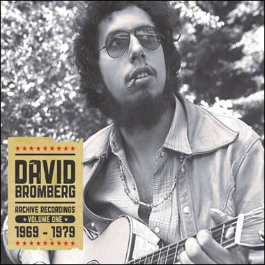 A person with a beard and sunglasses playing a guitar
Description automatically generated