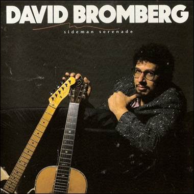 A person holding two guitars
Description automatically generated