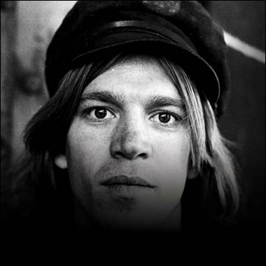 A person with long hair wearing a hat
Description automatically generated