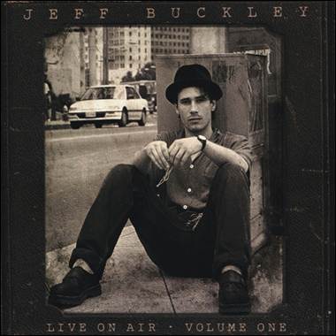 A person sitting on the sidewalk
Description automatically generated