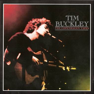 A person playing guitar on a stage
Description automatically generated