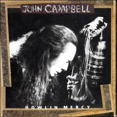 A person with long hair and a snake
Description automatically generated