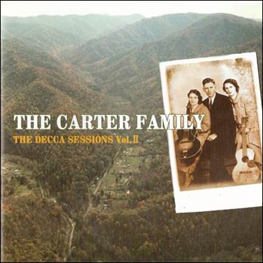 A group of people standing in front of a mountain
Description automatically generated