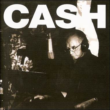 A person playing piano with a microphone
Description automatically generated