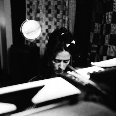 A person sitting at a desk
Description automatically generated