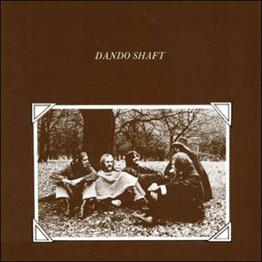 A group of people sitting in the grass
Description automatically generated