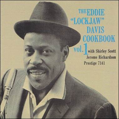 A person in a hat and suit
Description automatically generated