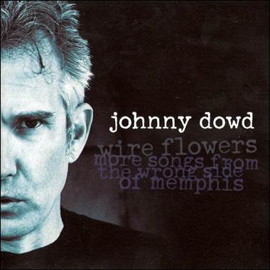 A person with grey hair and a black shirt
Description automatically generated