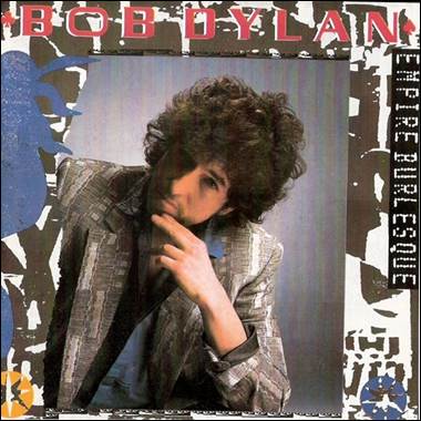 A person with curly hair and a suit

Description automatically generated