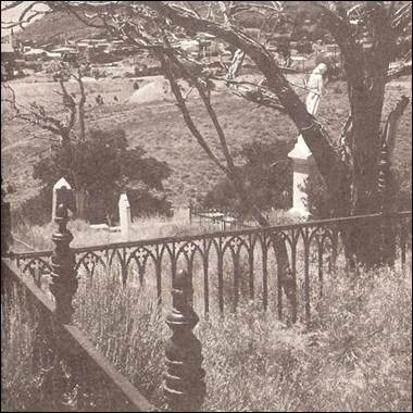 A fence with a statue in the background

Description automatically generated