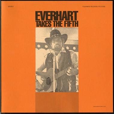 A person playing guitar on an orange cover
Description automatically generated