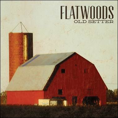 A red barn with a silo
Description automatically generated