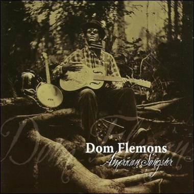 A person sitting on a log playing a guitar
Description automatically generated