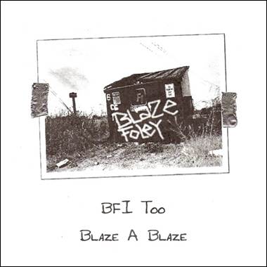 A black and white photo of a building with graffiti
Description automatically generated