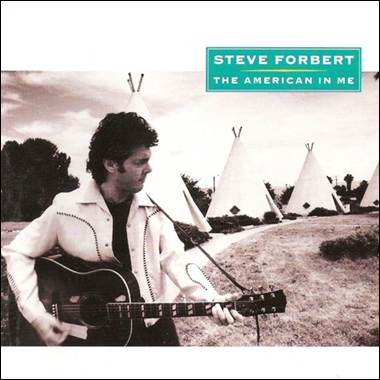 A person playing guitar in front of teepees
Description automatically generated