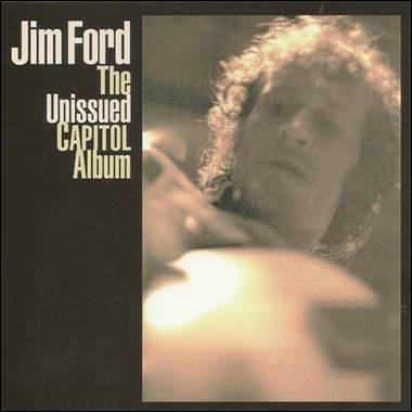 A person with curly hair and a guitar
Description automatically generated