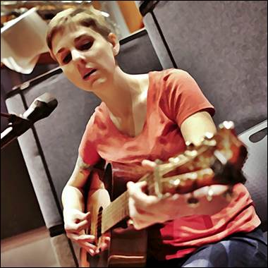 A person playing a guitar
Description automatically generated