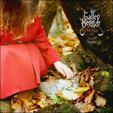 A child in a red coat playing with a squirrel
Description automatically generated