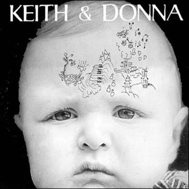 A baby with drawings on his forehead
Description automatically generated