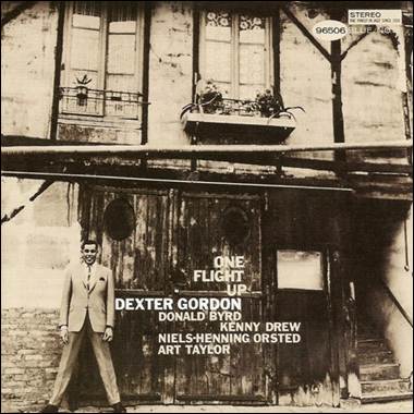 A person standing in front of a building
Description automatically generated