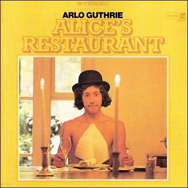 A person sitting at a table with a glass of wine
Description automatically generated