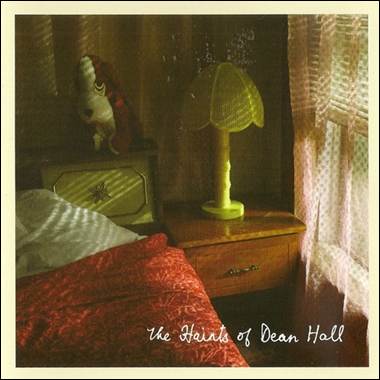 A lamp on a nightstand next to a bed

Description automatically generated