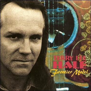 A person with long hair and a guitar
Description automatically generated