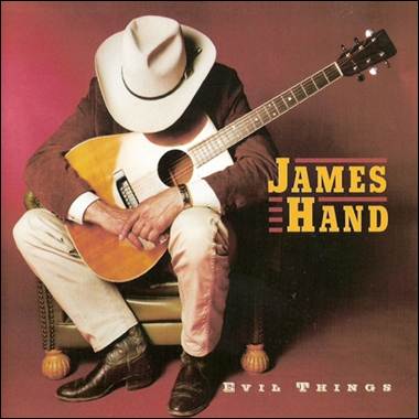 A person in a cowboy hat playing a guitar
Description automatically generated