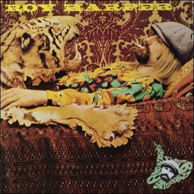 A person lying on a couch with a tiger
Description automatically generated