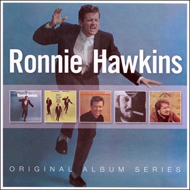 A person in a suit dancing

Description automatically generated