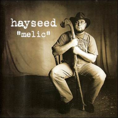 A person in a cowboy hat holding a cane
Description automatically generated