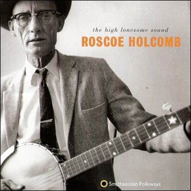 A person in a suit and tie holding a banjo
Description automatically generated