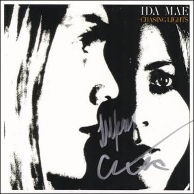 A person's face with a signature on a cover
Description automatically generated