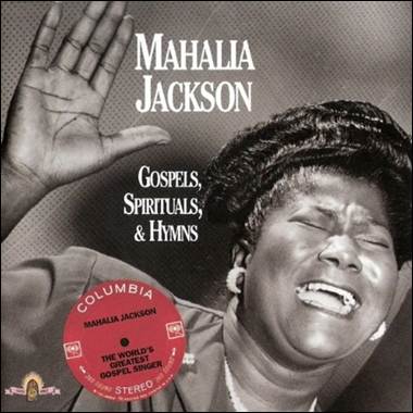 A person with her hand up and her mouth open
Description automatically generated