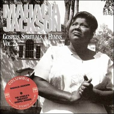 A person standing outside a house
Description automatically generated