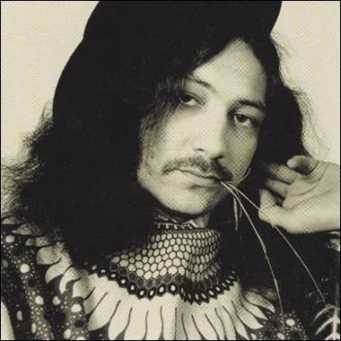 A person with long hair and a hat
Description automatically generated