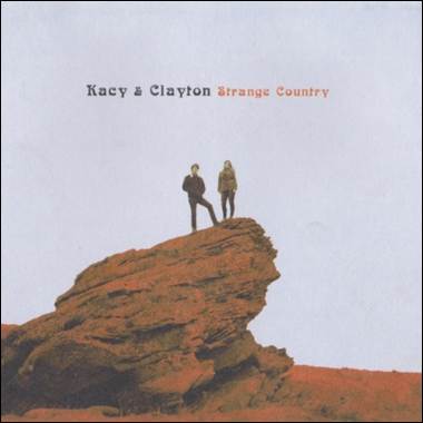 A person and person standing on a rock
Description automatically generated