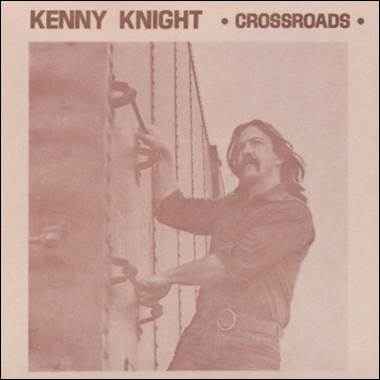 A person with a mustache holding onto a wall
Description automatically generated