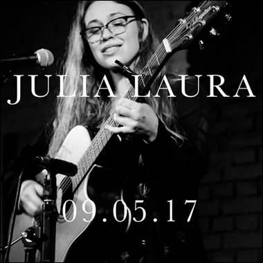 A person playing guitar and singing
Description automatically generated