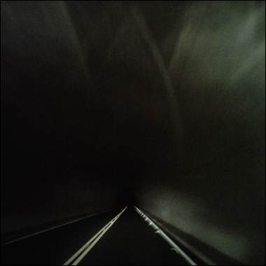 A dark tunnel with a road and light

Description automatically generated with medium confidence