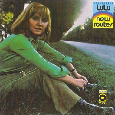 A person sitting on the side of a road

Description automatically generated