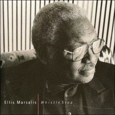 A person wearing glasses and a black shirt
Description automatically generated