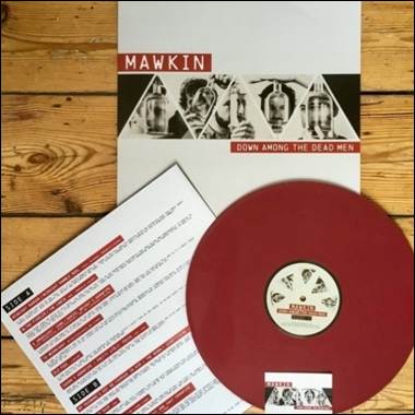 A red vinyl disc and a white paper on a wooden surface
Description automatically generated