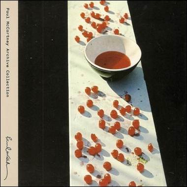 A bowl of liquid and cherries on a white surface
Description automatically generated