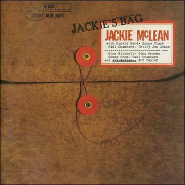 A brown envelope with red and white labels
Description automatically generated